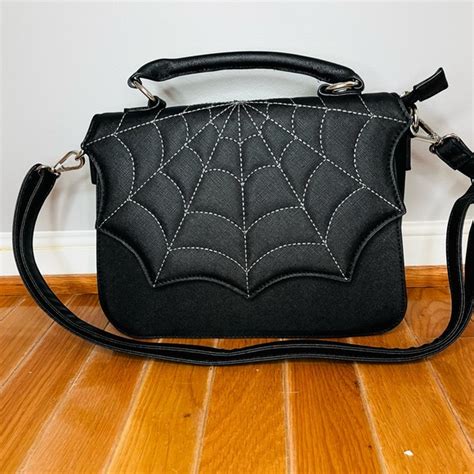 Bag measures Width - 5 12 inches Depth - 5 34 inches Height - 7 12 inches New, with tags. . Mad engine spider web bag